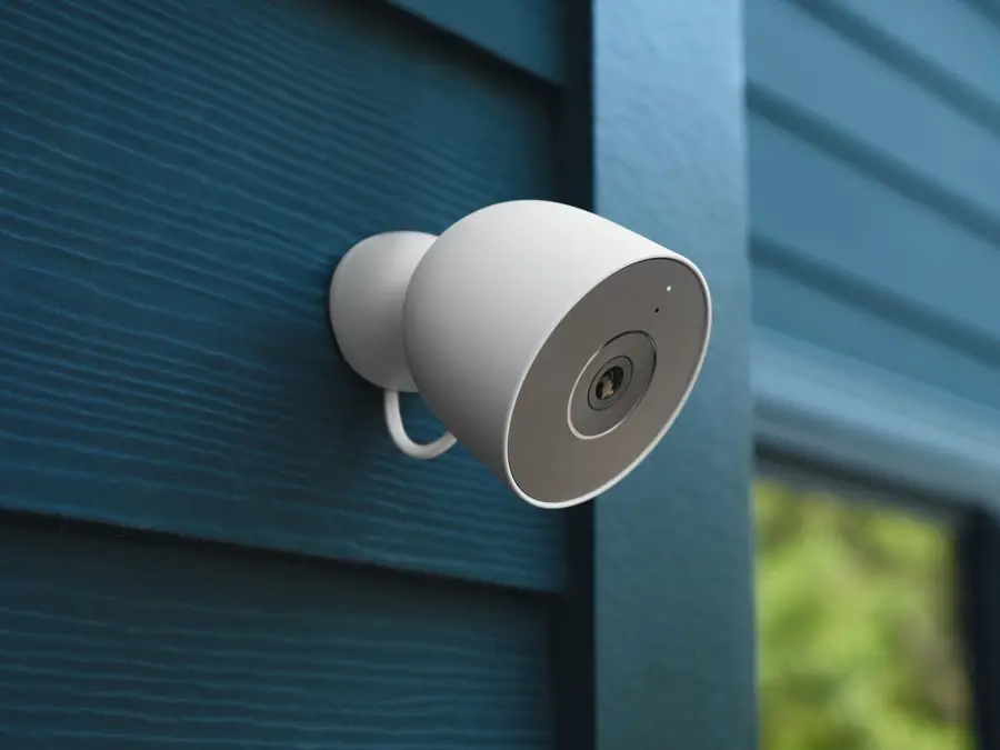 Outdoor security camera mounted on a blue house